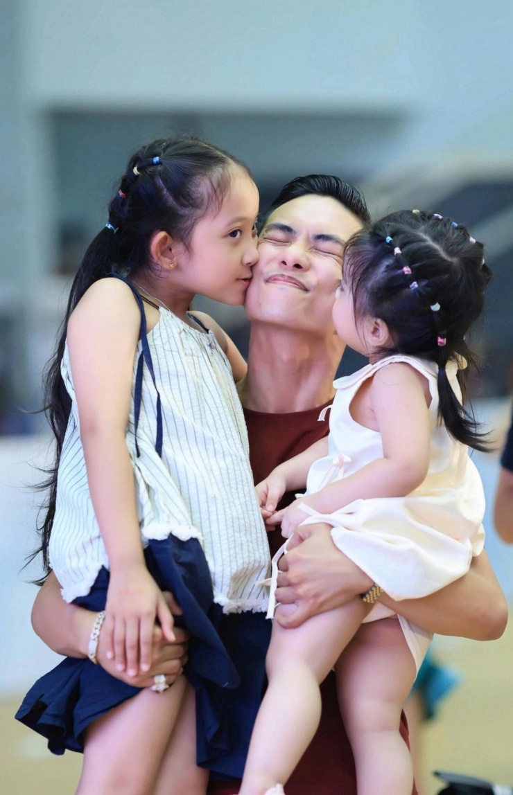 Vũ công Phan Hiển hạnh phúc khi được 2 con gái nhỏ thơm má. 